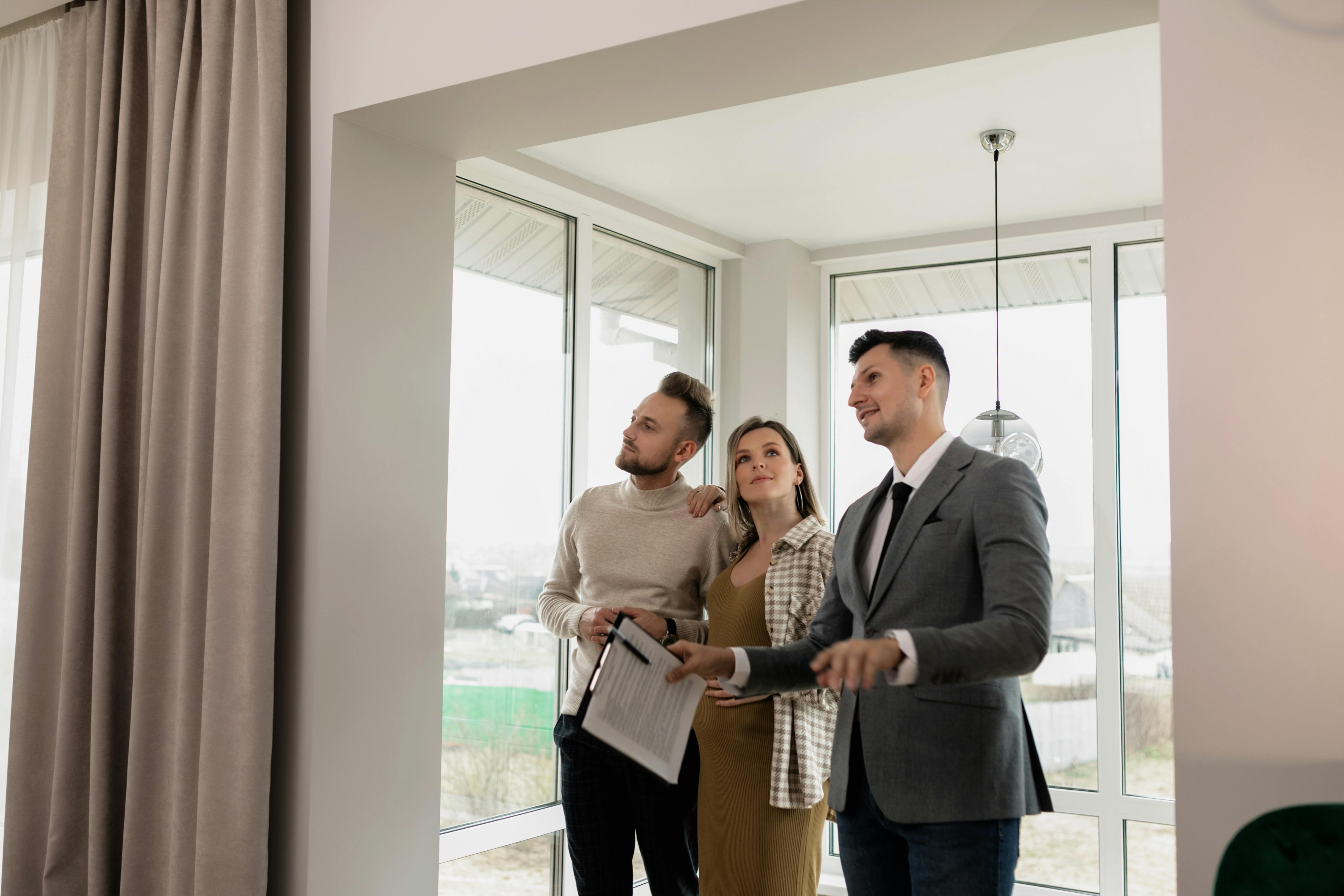 A realtor showing a house to a couple